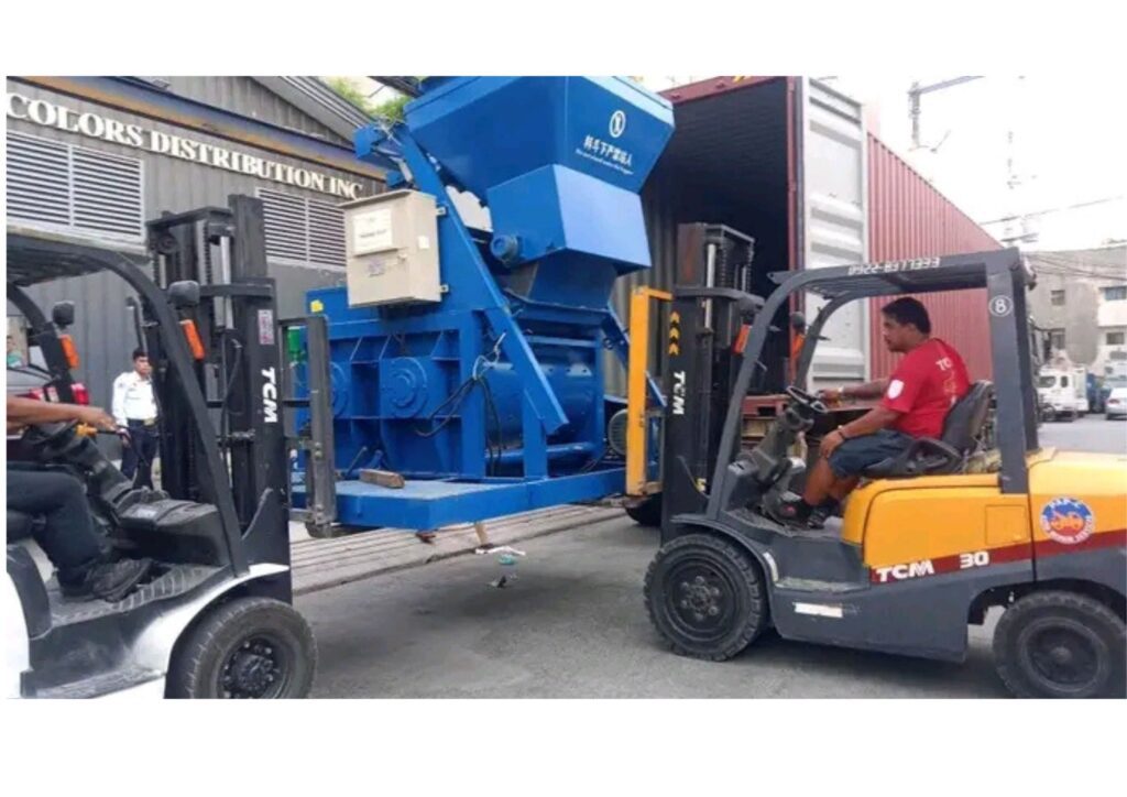 Dual forklift unloading heavy industrial equipment from container in Lagos Nigeria