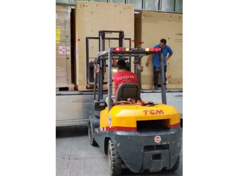 Forklift loading wooden crates into truck at warehouse in Lagos Nigeria